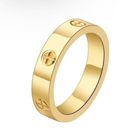 Gold ring with engraved symbols on a white background