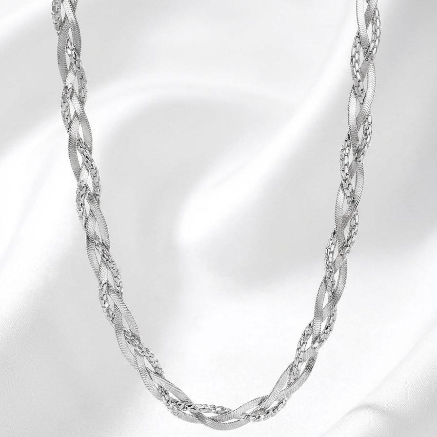 Silver chain necklace on a soft white background