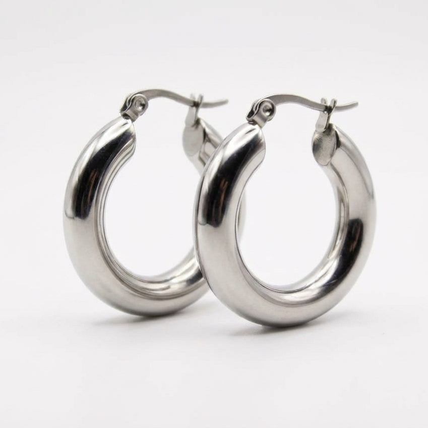 Pair of silver hoop earrings on a white background