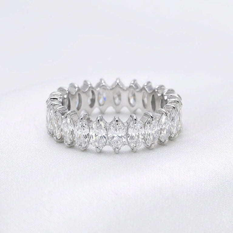 Silver ring with multiple diamonds on a white background