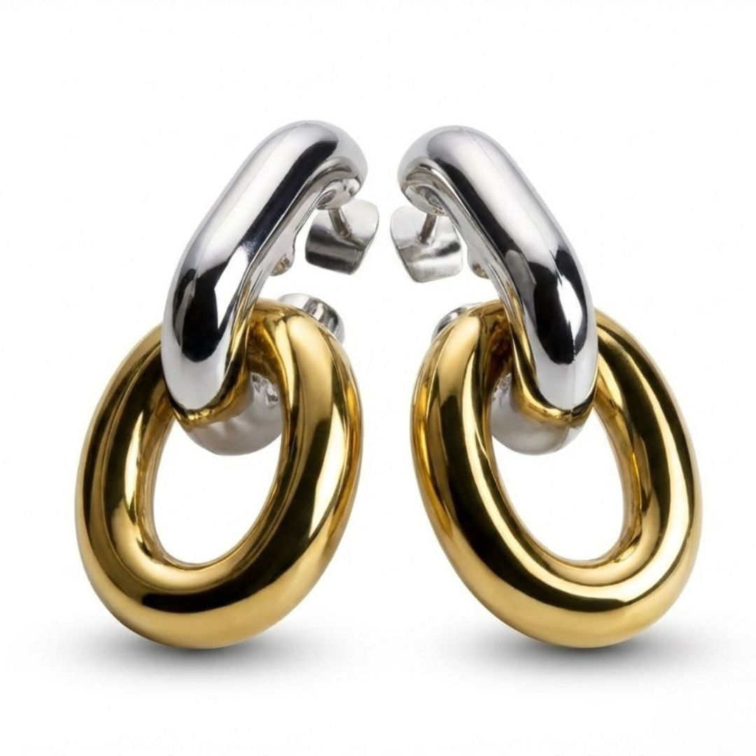 Pair of gold and silver hoop earrings on a white background