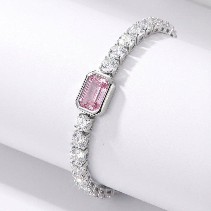 Elegant bracelet with a pink gemstone on a white surface