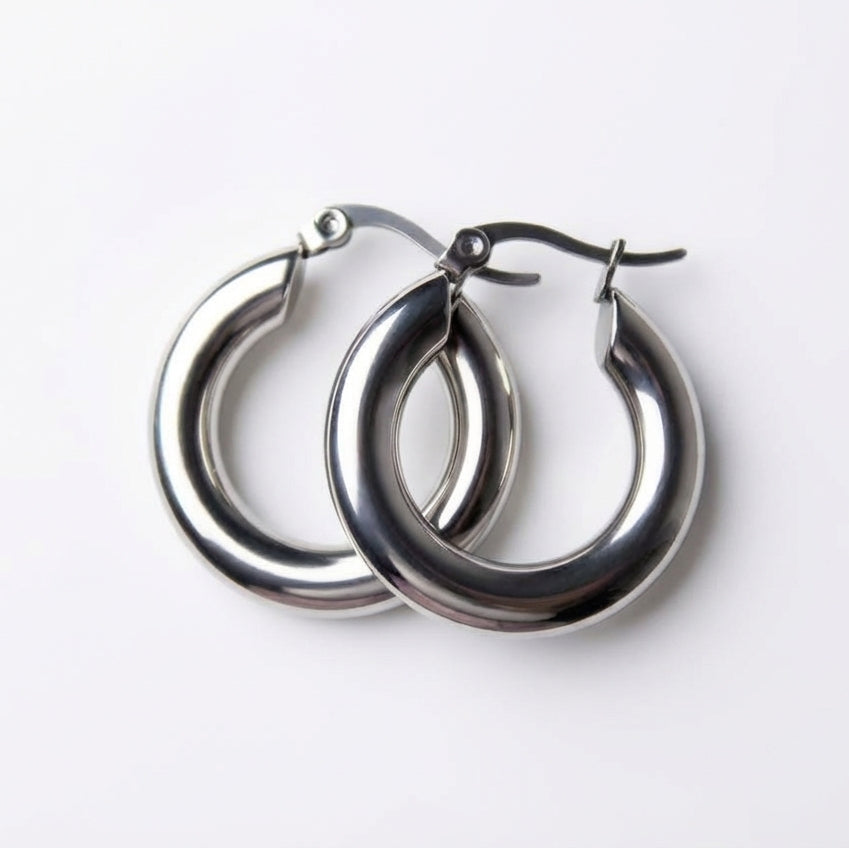 Pair of silver hoop earrings on a white background