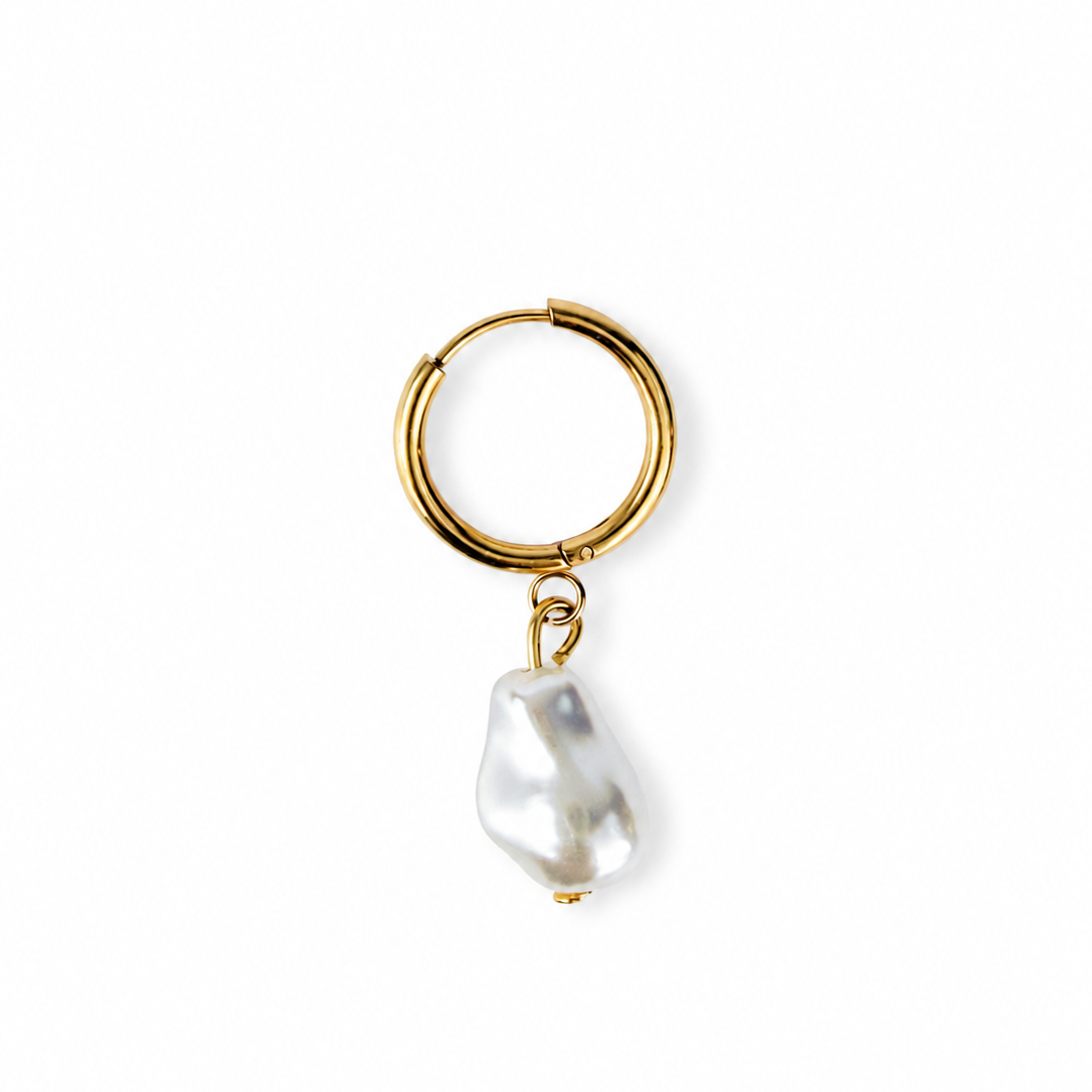A gold hoop earring with a dangling baroque pearl, shown on a clean white background.