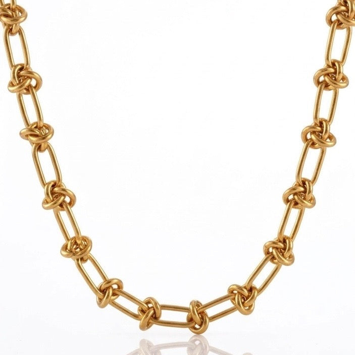 Gold chain necklace on a white background