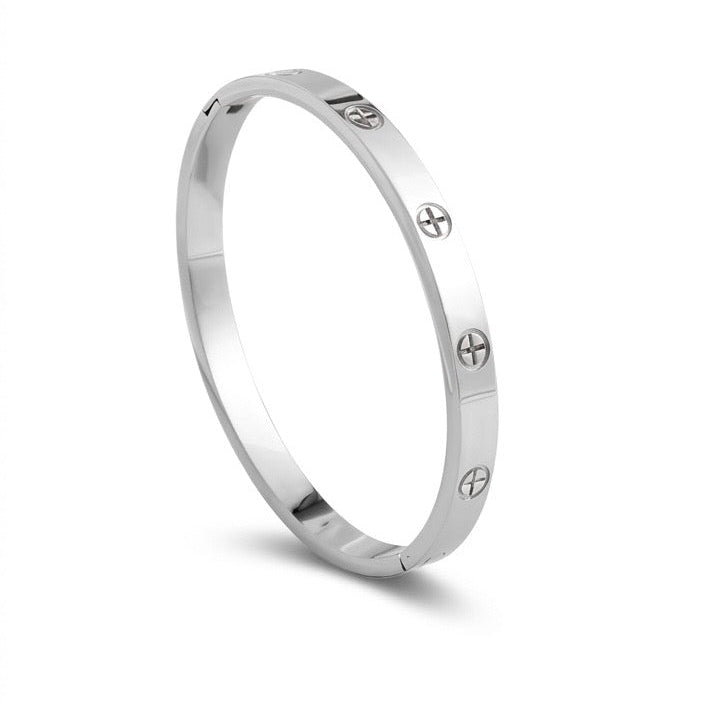 Silver ring with engraved symbols on a white background
