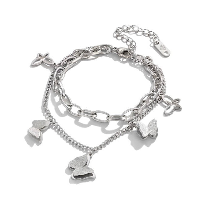Silver bracelet with heart-shaped charms on a white background
