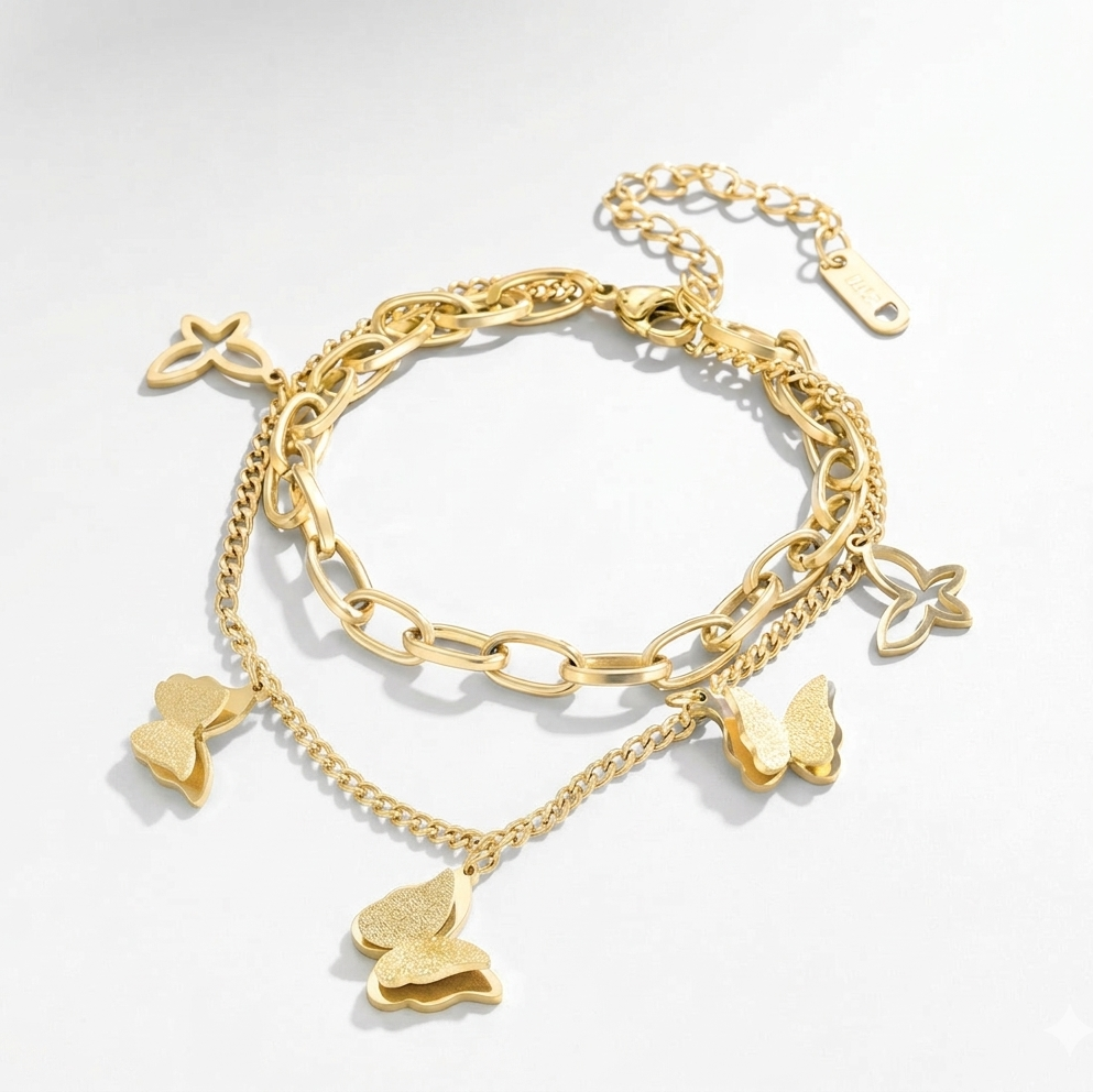 Gold bracelet with butterfly charms on a light gray background