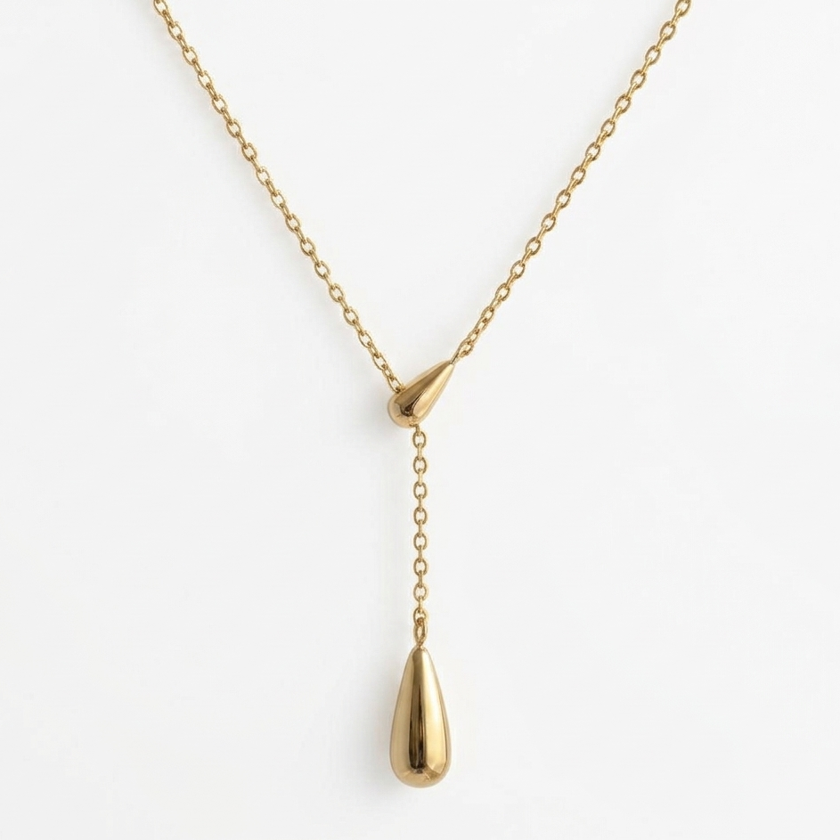 Gold necklace with a teardrop pendant on a white background
