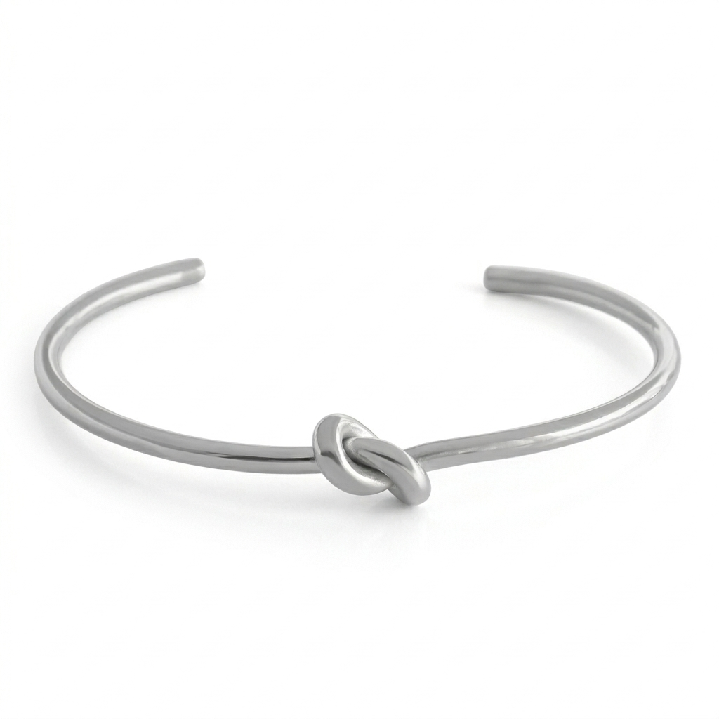 Silver bracelet with a knot design on a white background