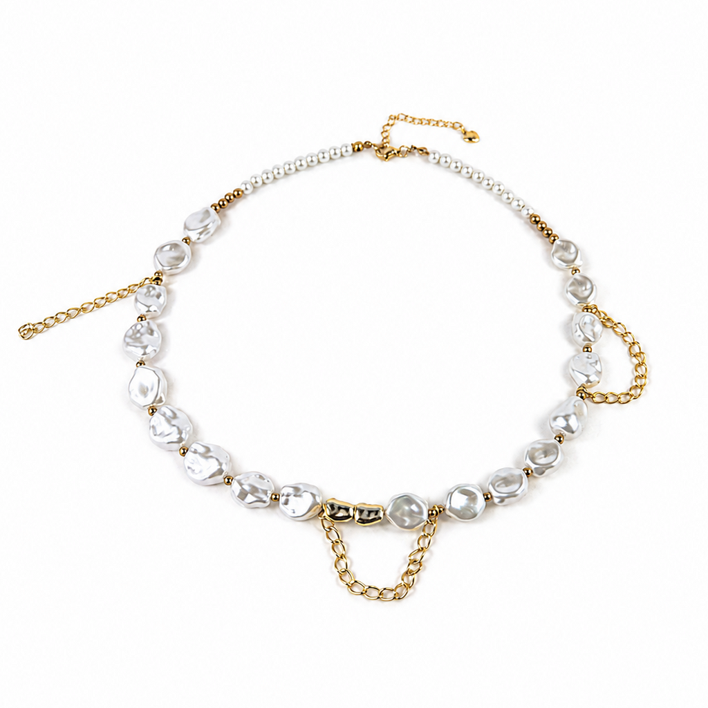 A gold chain necklace featuring a strand of irregular white faux pearls and clear faceted glass beads, displayed on a clean white background.