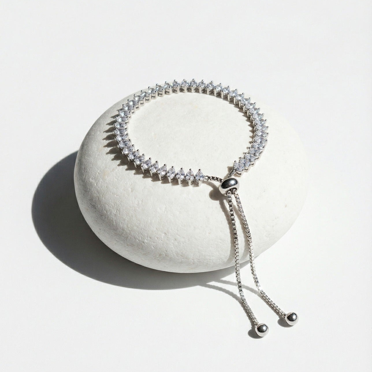 Silver beaded bracelet on a white stone surface