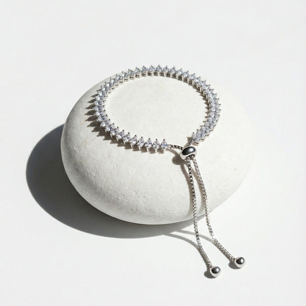 Silver beaded bracelet on a white stone surface