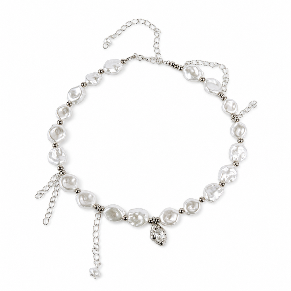 A silver-toned baroque pearl necklace with dangling charms, including a small rhinestone-encrusted teardrop pendant, displayed on a clean white background.