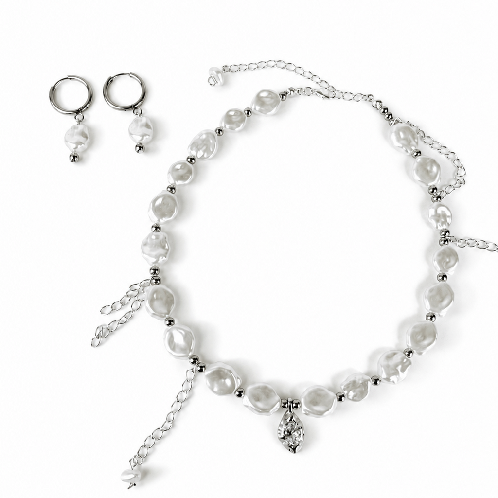 A silver-toned jewelry set featuring a beaded necklace with irregular white pearl-like beads, matching drop earrings, and a small dangling charm, displayed on a clean white background.