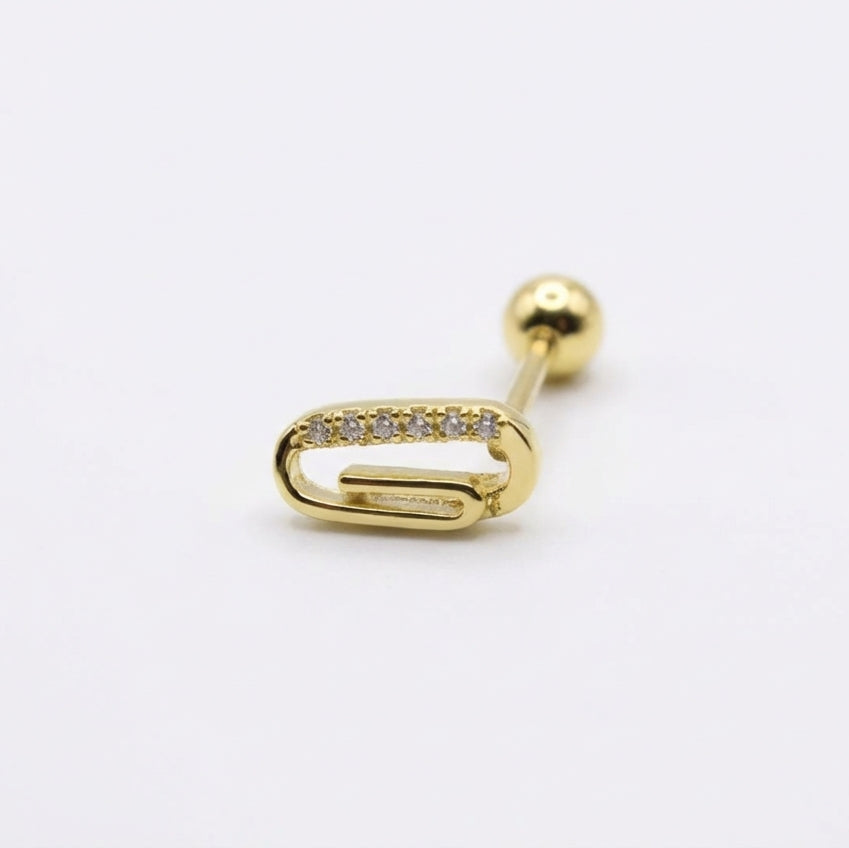 Gold earring with a clear gemstone on a white background